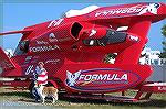 Andrea Barnes and therapy dog King check out one of the offshore racers at the staging grounds at Sunset Marina.