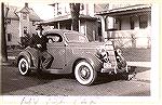 Jack Barnes Sr, father of Ocean Pines resident Jack Barnes who is attempting to identify model and year of car. It ended up being a 1935 Ford 3 window coupe "deluxe". [due to whitewalls, hood ornament
