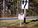 Sign in median of Ocean Parkway near North Gate advertising Pop's (something) Shop. Open Saturday and Sunday at 82 Seafarer Lane. About six similar signs are placed along the parkway from the North Ga