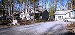 Pop's Shop at 82 Seafarer Lane. Note sign on left says "please park in driveway" and "five cars only." Sign also offers "free gift."