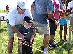 Ocean Pines Anglers Club member Bill Bundy helps Liam O'Toole learn to cast.