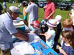 Lee Phillips, Anglers Club member shows youngster what "real" fish look like at the annual Ocean Pines Anglers Club Teach a Kid to Fish event.