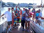 Believe In Tomorrow families prepare for boating trip with captains Fred Stiehl [far left], Ricky Kerrigan [back with red hat] and Dick Scarbath [far right].