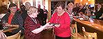 Mary Adair, incoming president of the Worcester County Veterans Memorial at Ocean Pines, presents a plaque of appreciation to outgoing president Marie Gilmore during annual gathering at Denovos. Denov