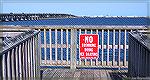 No Ice Skating sign at wharf overlooking Assawoman Bay.