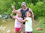 Sadie and friend Trista haul in a big fish to show Sadie's dad Dan.  