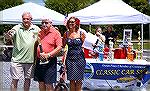 Jim Mathias (left) presents a winning trophy in the Ocean Pines Chamber of Commerce Classic Car Show.