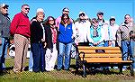 Some of those attending a ceremony to dedicate a bench in honor of Bob Abele on Ocean Parkway between Wood Duck 1 & Wood Duck 2 to the north of the mail boxes. Abele in at right-center, just to the ri