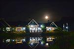 The Parke clubhouse at night with a nice full moon rising and cool reflections in the pond