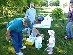 Frank Daly and Pat Connelly try to convince young angler Brin that the bait will not bite at the Teach A kid To Fish event.