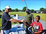 Angler Frank Fiori explains fish identification to Kenai and his Dad Kenny.
The Ocean Pines Anglers Club hosted the annual Teach A Kid To Fish event on Saturday at the South Gate Pond. . Beautiful we