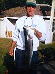Jack Barnes shows his 35", 16lb Maryland citation Rockfish caught in 2002