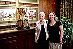 Jeanette Reynolds (left) and Amy Wong pose next to the President's Cup Trophy at The Players Club in Sawgrass, Florida.