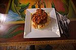 Veal Osso Buco served over pineapple risotto and topped with a tomato reduction sauce.