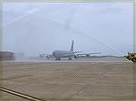 Lt. Col Jack Barnes III, Squadron Commander of the 147th  Air Refueling Wing brings in the KC-135  tanker through a celebratory spray on his last retirement flight after 26 years of service.