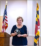 Description: Introductory presentation by Director of Ocean Pines Recreation and Parks Debbie Donahue in presentation of the 2021 Sam Wilkinson Volunteerr of the Year Award to MarieGilmore: 
Good mor