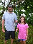 Ocean Pines Angler Club member Mike Vitak presents his hand made custom rod and reel to Grand Prize drawing winner Kenzie Stopper. 